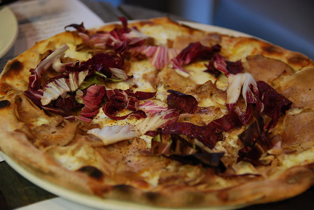 Thin crust vegetable pizza slice