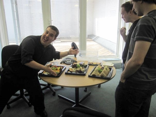 happy employee next to catered lunch