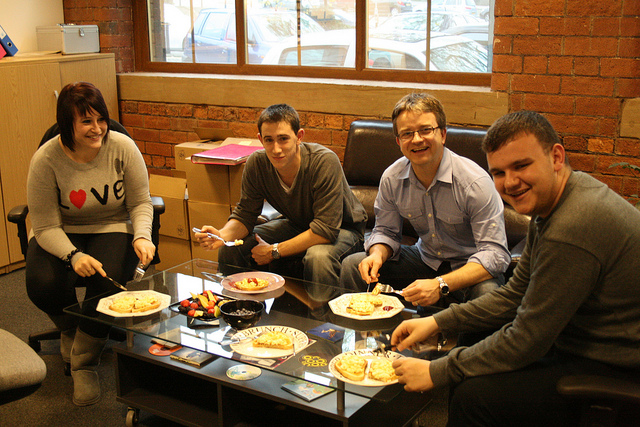 coworkers in break room with real dishes