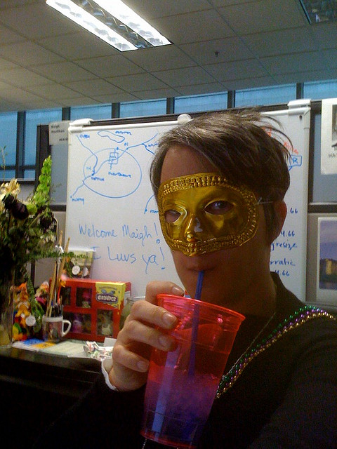 office worker with glass and Mardi Gras mask