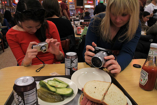 girls taking photos of food