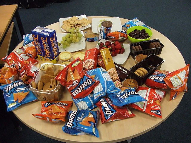 table of bags of chips and fruit