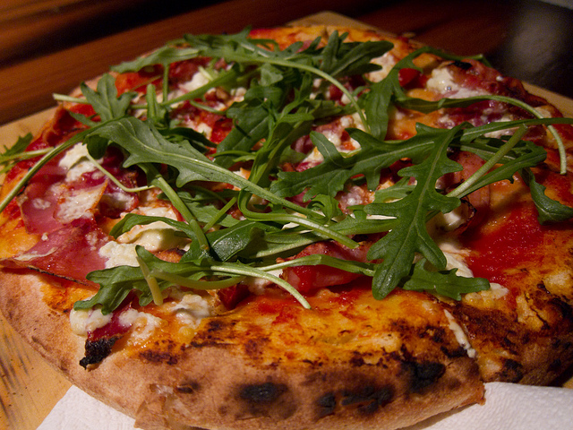 pizza with arugula on top