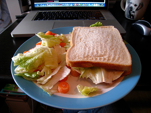 sandwich and salad at desk for a healthy office lunch