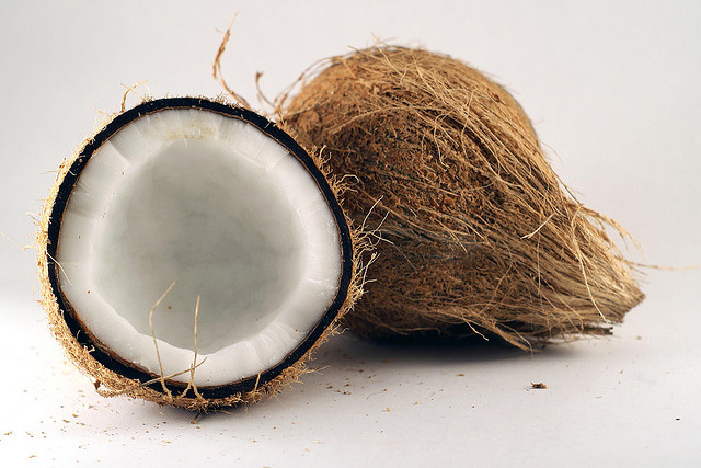 A coconut, sliced in half.