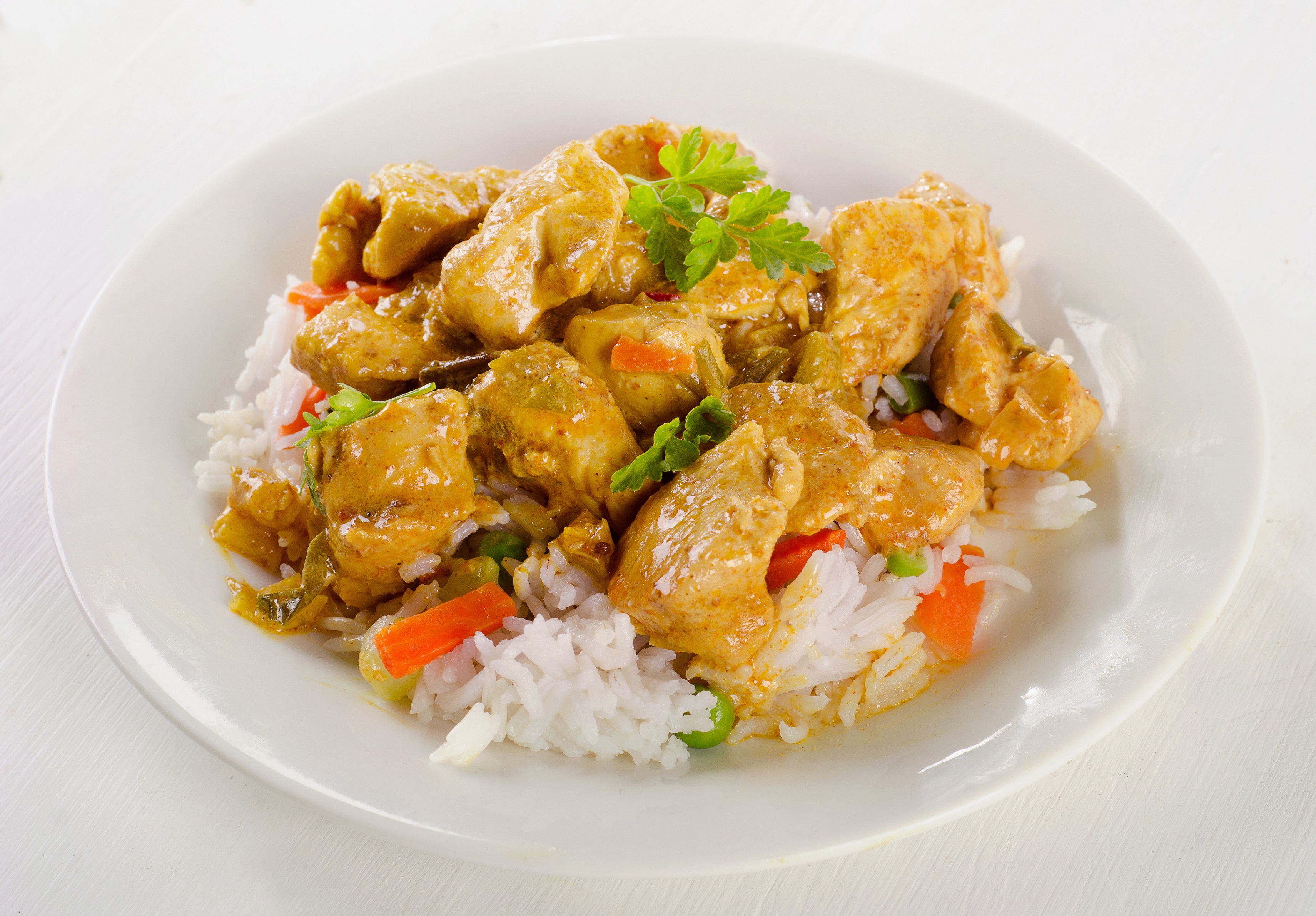 Chicken Curry and rice on a white plate. - Waiter.com Food Delivery Blog